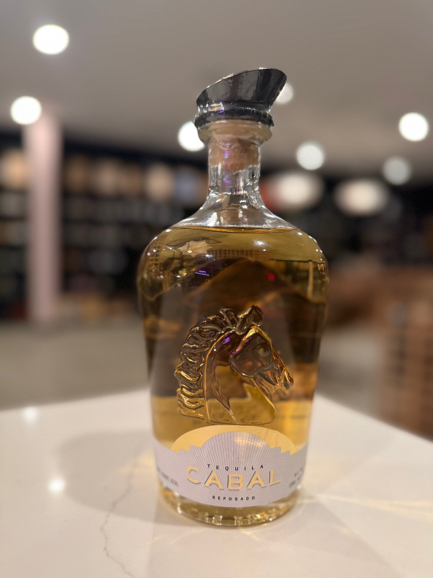 Bottle of Cabal brand liquor on a counter with blurred background