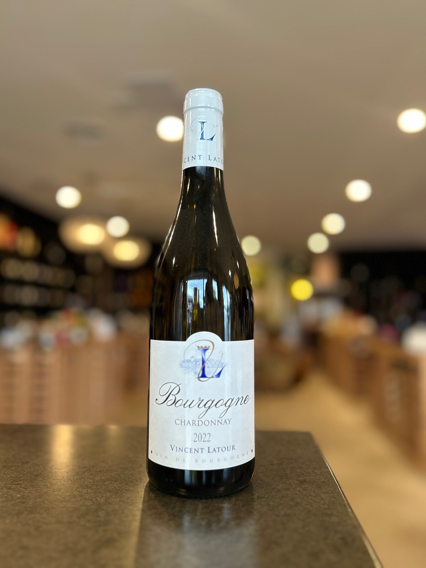 Bottle of Bourgogne Chardonnay wine on a counter with a blurred background