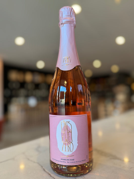 Bottle of rosé wine with a pink label on a blurred background